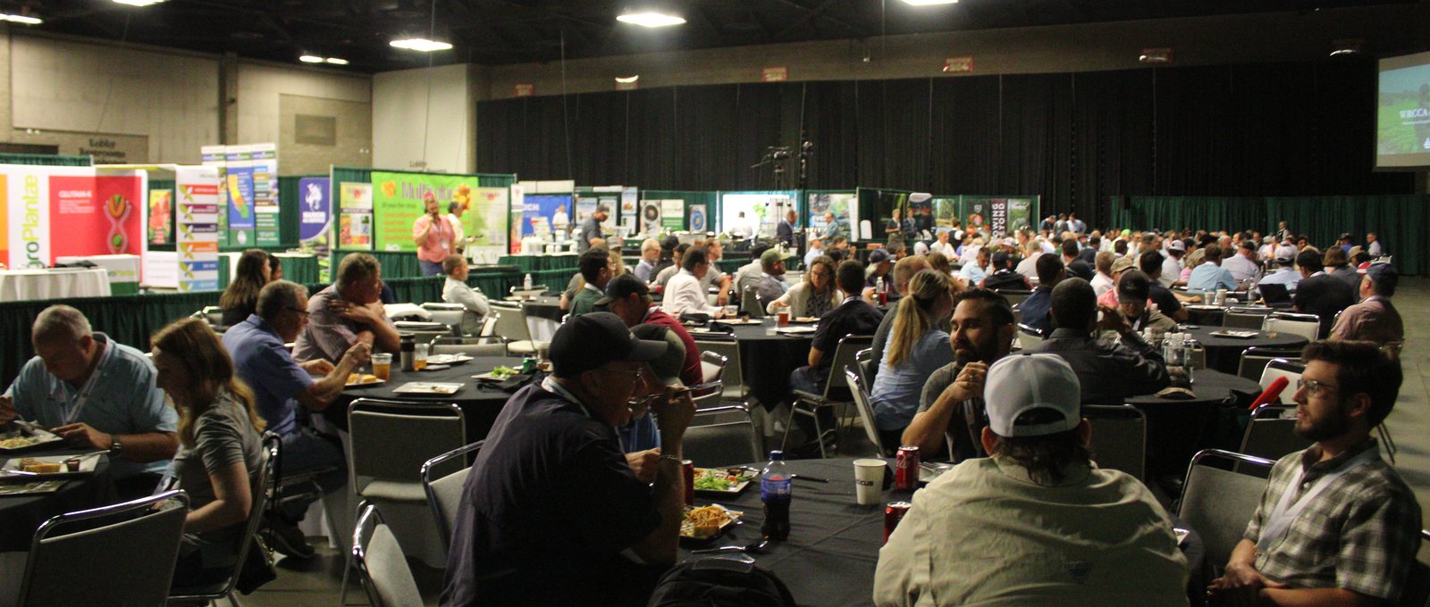 A packed lunch crowd of PCAs and CCAs at the Crop Consultant Conference, with exhibitor booths lining the hall